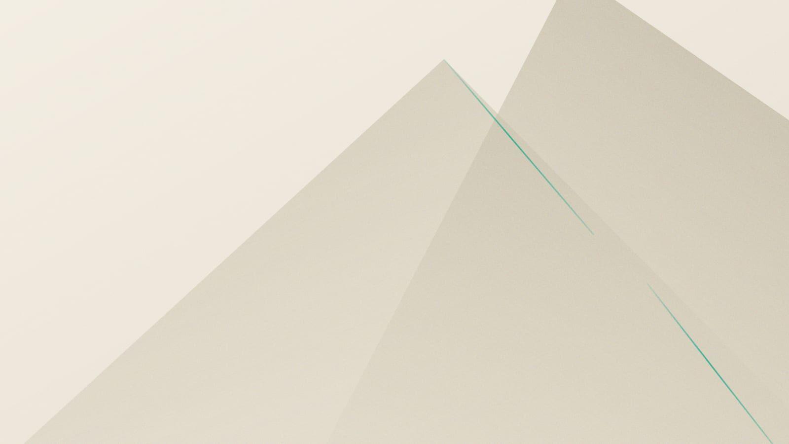 Two warm grey planes meeting at a thin teal seam on a cream field